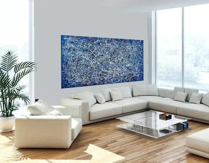 Large Blue and Silver Abstract Drip Painting – Navy Pollock Style displayed in bright white minimalist living room – LargeModernArt.com