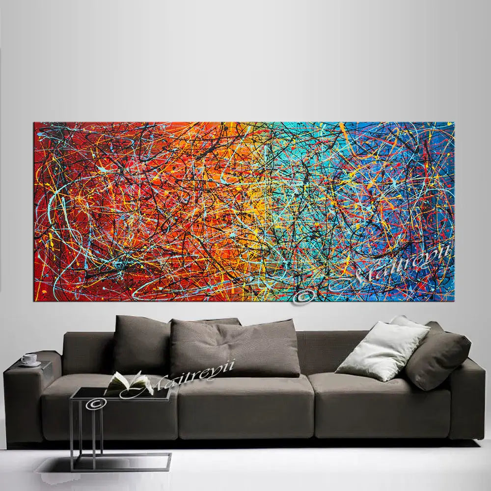 Jackson Pollock Style abstract modern art painting displayed above a gray sofa in a contemporary living room.