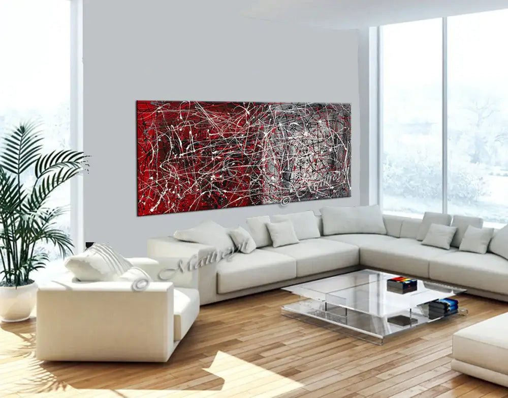 Jackson Pollock Style painting displayed in a modern living room, showcasing vibrant red and textured layers.