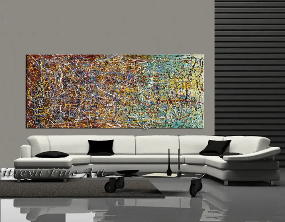 Abstract painting in Jackson Pollock Style displayed above modern couch in stylish living room.